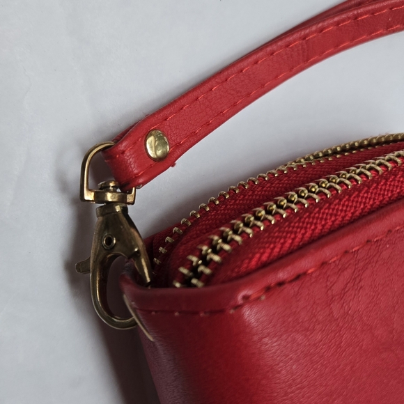 Red wallet with 2 zipper compartments and a wrist handle. - Picture 11 of 12